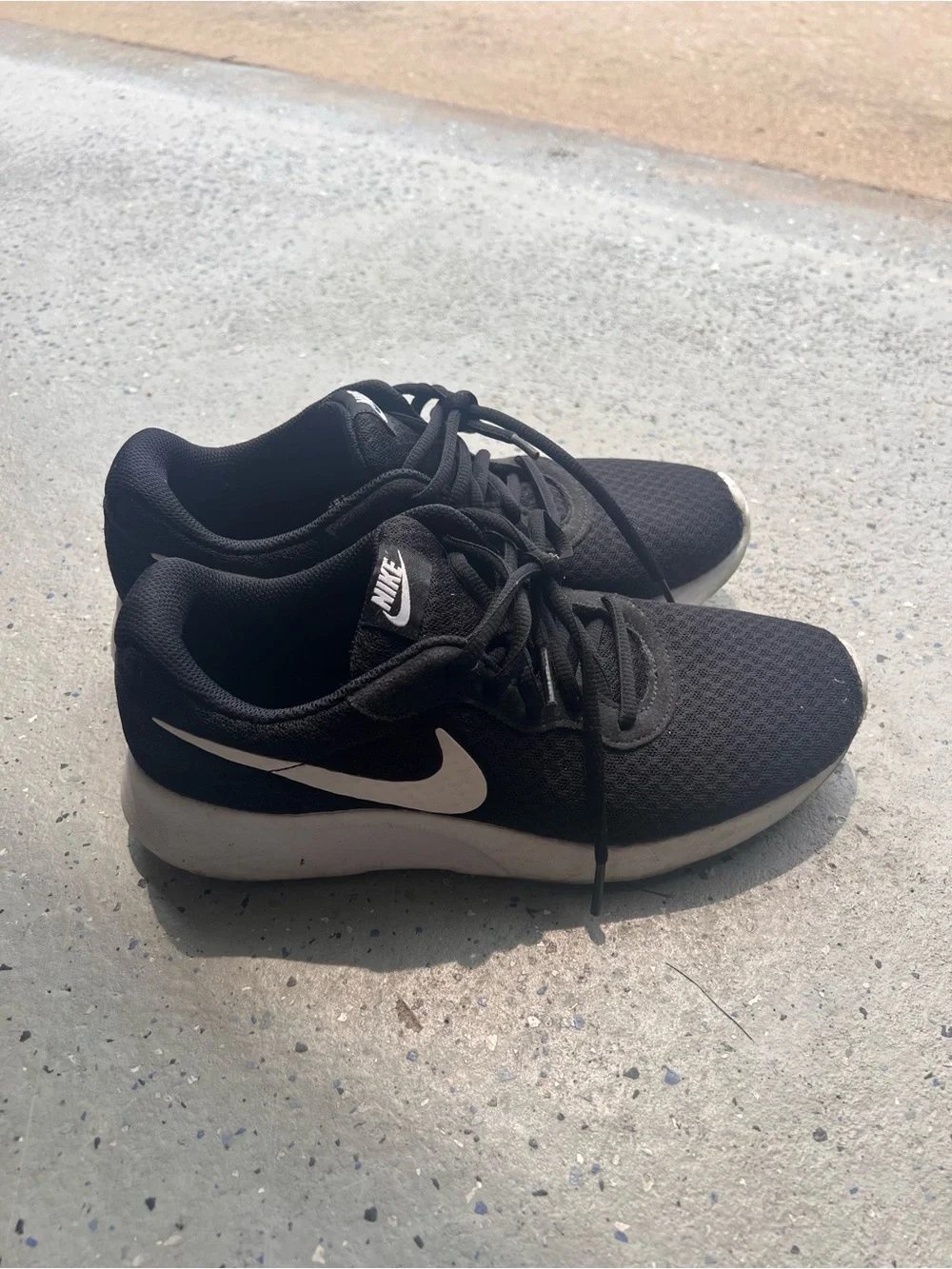 Nike Women’s Black Running Shoes with White Swoosh